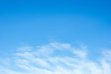 Background gradient blue sky with fluffy light white clouds. Natural background. Can be used to replace the sky in a photo