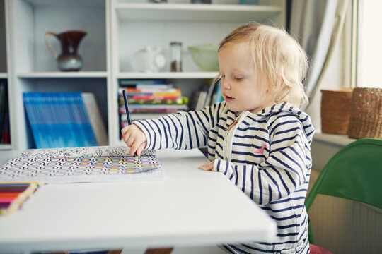 Little toddler girl colouring in