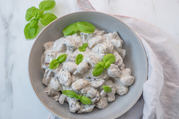 home made gnocchi with mushrooms and arugula