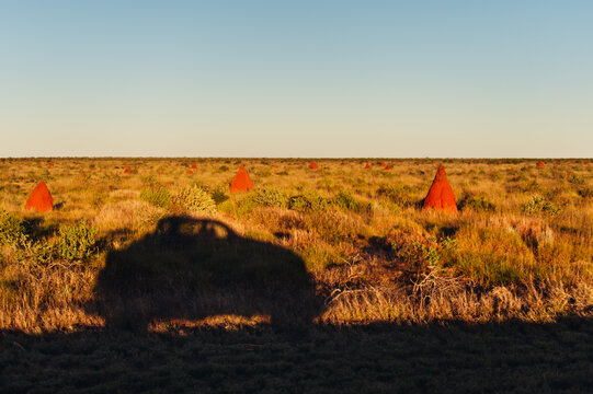 Shadow of a car amongst ant hills on the Ningaloo Coast