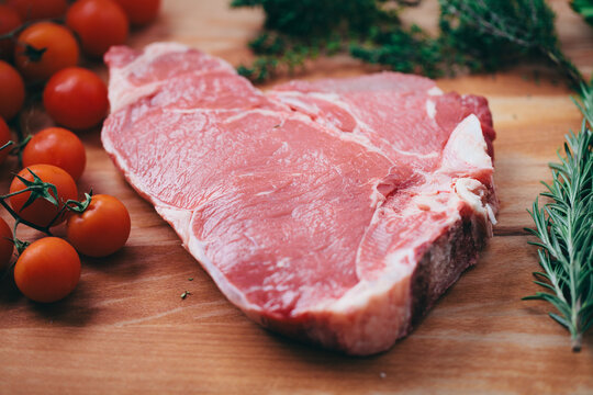 Raw steak on cutting board