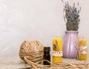 Composition with accessories for making wax candles with your own hands and a vase with lavender flowers.