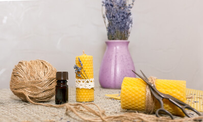 Composition with accessories for making wax candles with your own hands: wax plate, scissors, jute, aromatic oil, dried flowers.
