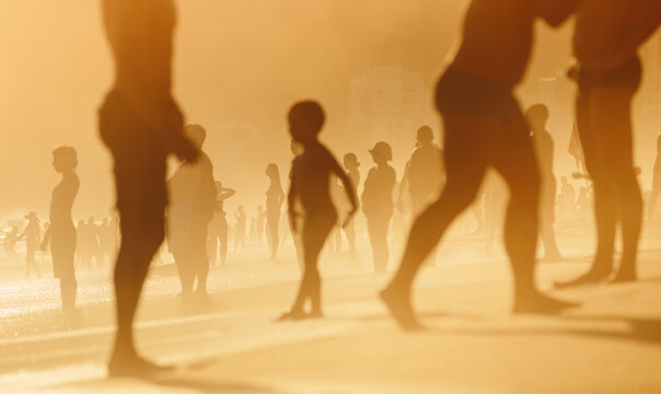 A group of beach goers enjoy the last bit of hazy summer sun in Rio De Janeiro, Brazil
