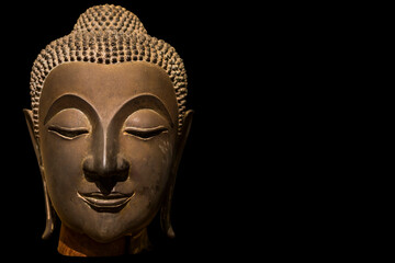Fototapeta na wymiar Ancient Buddha Face isolated on black background