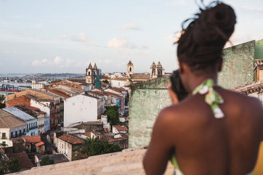 Brazil. Woman taking pictures from a view point in Salvador de Bahia