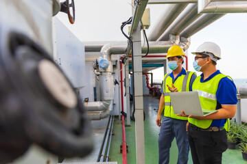 Two Asian Male engineering working at factory.