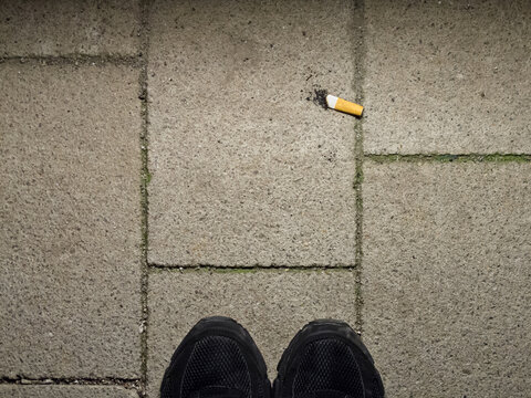 Finished cigarette stub on floor, concept: final cigarette
