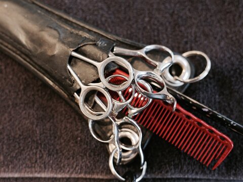 barber scissors and combs in a leather holster