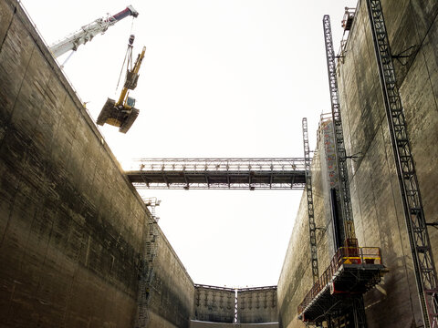 Crane Lifting Excavator From Public Infrastructure Construction
