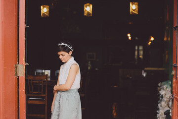 Girl in a skit in the doorway of a restaurant