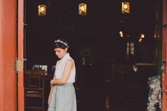 Girl in a skit in the doorway of a restaurant