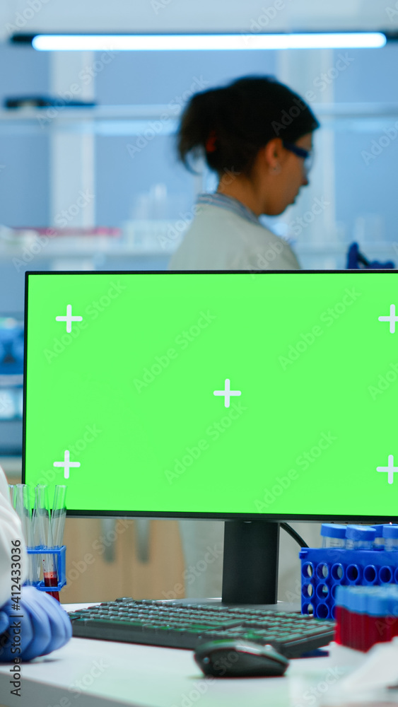 Aufkleber researcher looking at chroma key display in modern equipped lab analysing virus evolution. team of m