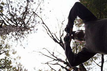 Man looking through binoculars in nature