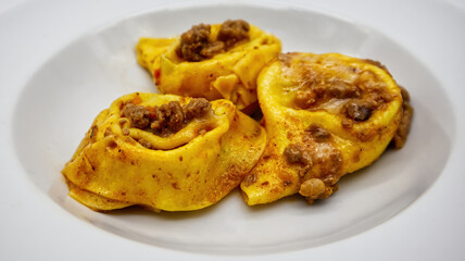 Tortelloni with bolognese sauce, ricotta cheese and spinach. Traditional italian pasta. Selective focus 

