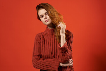 cheerful emotional woman in red sweater lifestyle red background casual wear