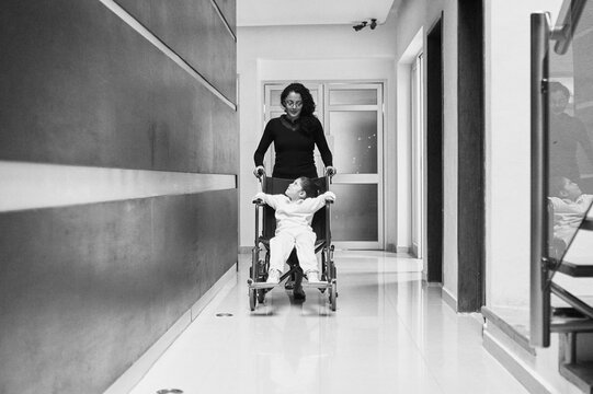 Girl in wheel chair looking at her mother