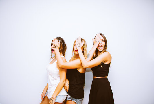 Three funny women with hands painted