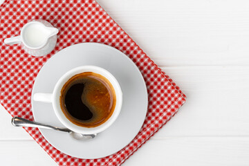 Cup of espresso coffee on saucer close up