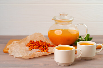 Sea buckthorn tea served on wooden table