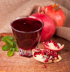 ripe pomegranate with leaves on a wooden board