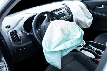 Airbag exploded at a car after the accident. Driver and Passenger AirBag. Car crash. Interior of a...