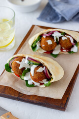 Falafel in pita with tomatoes, cucumbers, onions and spinach. Healthy eating. Vegetarian food.