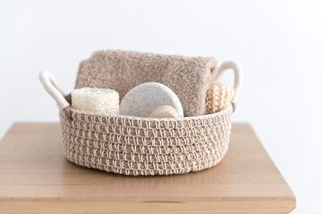 jute basket with body care products - organic soap, sponge, loofah and towel