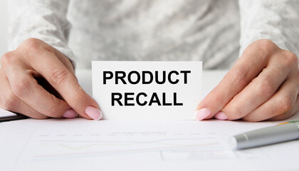 The girl holds a card with both hands with the product recall.