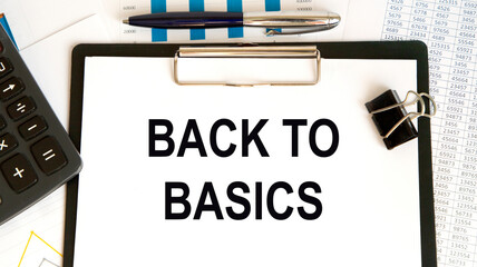 On the letter tablet is the text Back to Basics, next to the calculator, the paper clip, reports and graphs.