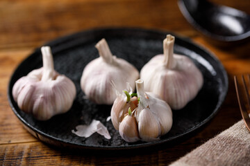 Close-up of garlic bulbs on a wooden table. Cooking concept.