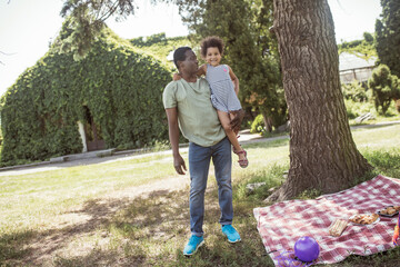 African american man and his daughter having good time together in the park