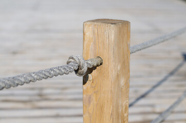Barrage. Knot. Rope fence. Rope. Wooden post.