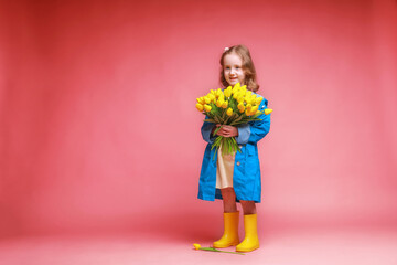 a little girl with yellow tulips in her hands and a watering can on a pink background