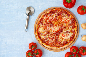 Delicious pizza with sausages on gray background