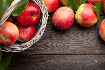 Naklejka na ściany i meble Ripe garden apple fruits in basket on wooden table