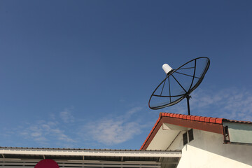 Satellite dish is on the roof of house.