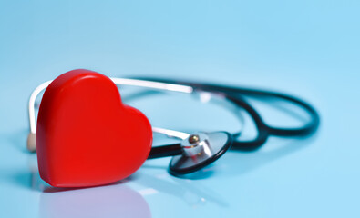 Red heart and a stethoscope on blue background.Medicine, healthcare, science concept.