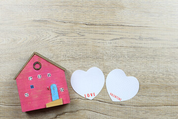 Paper heart shape and wooden house and have copy space.