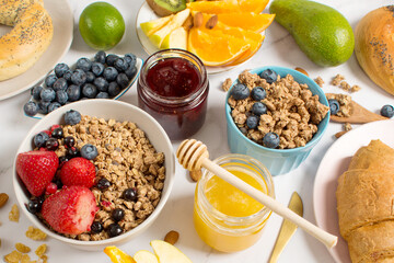 Breakfast table with oatmeal, croissants, fresh fruit