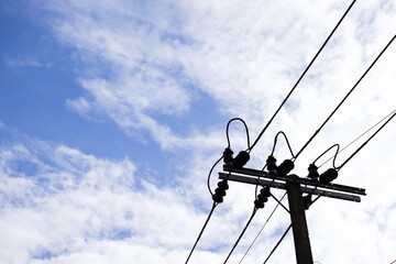 Silhouette electric pole blue sky.