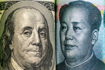 concept economic wars images of presidents with the dollar and the yuan looking at each other