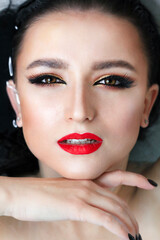 Beautiful young brunette model with bright make-up in bath, water