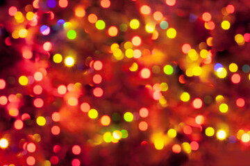 Colorful abstract background in yellow and red colors, carnival lights in bokeh. Festive blurred background
