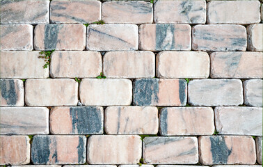 The paving blocks of marble. Textured image of cobblestone road marble. The cobbled street. Paving...