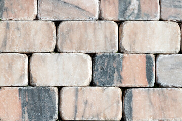 The paving blocks of marble. Textured image of cobblestone road marble. The cobbled street. Paving stones of streets. The texture and the background paving.