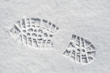 Clearly defined footprint / imprint in fresh snow of rubber lug sole with deep indentations from...