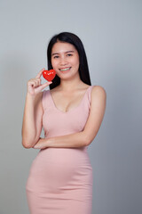 Asian woman holding and red heart shape