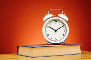 Vintage alarm clock on red background