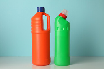 Blank bottles with detergent on blue background